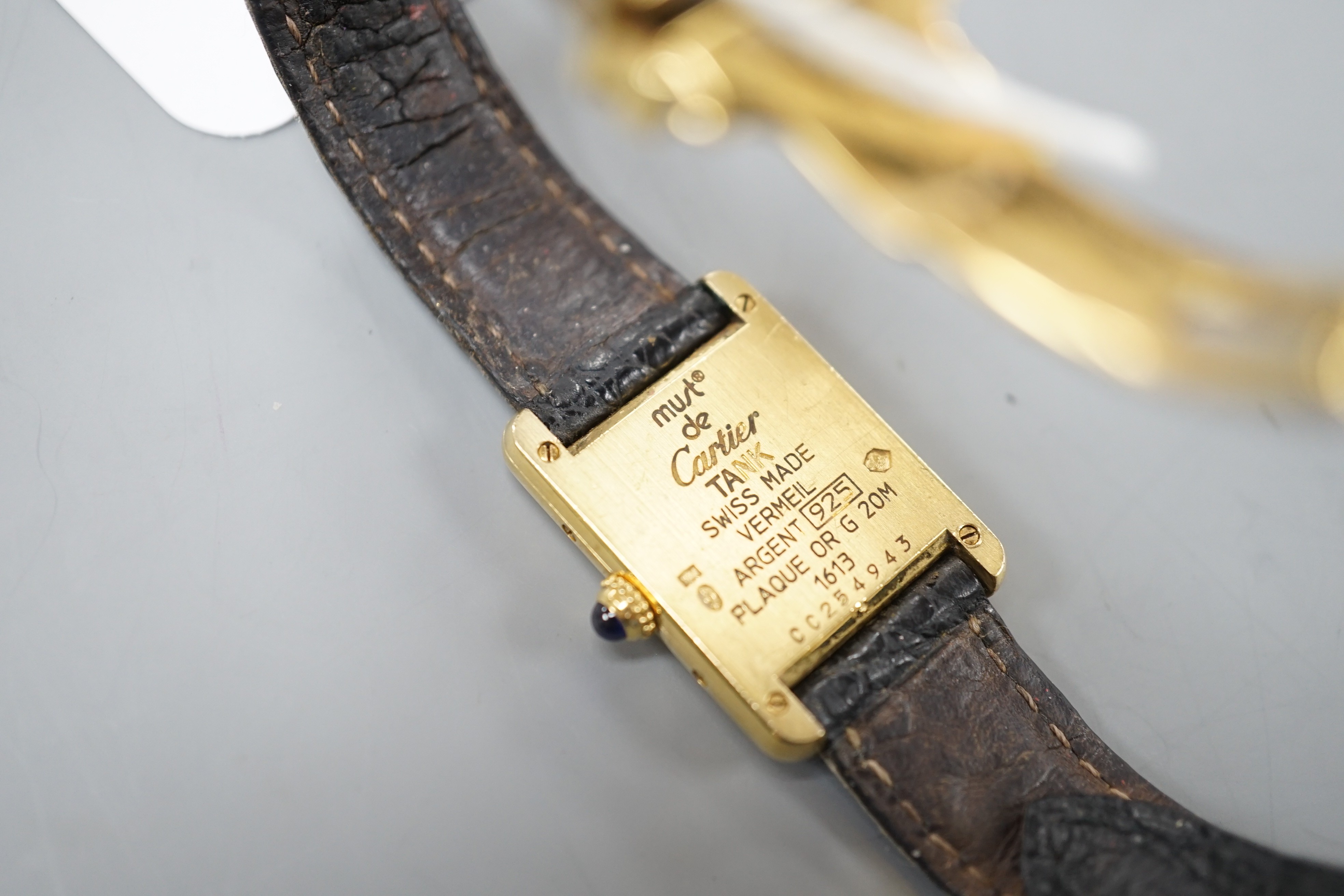 A lady's modern 925 gilt Must de Cartier rectangular quartz wrist watch, with three colour dial, on Cartier bracelet with gilt steel deployment clasp, no box or papers.